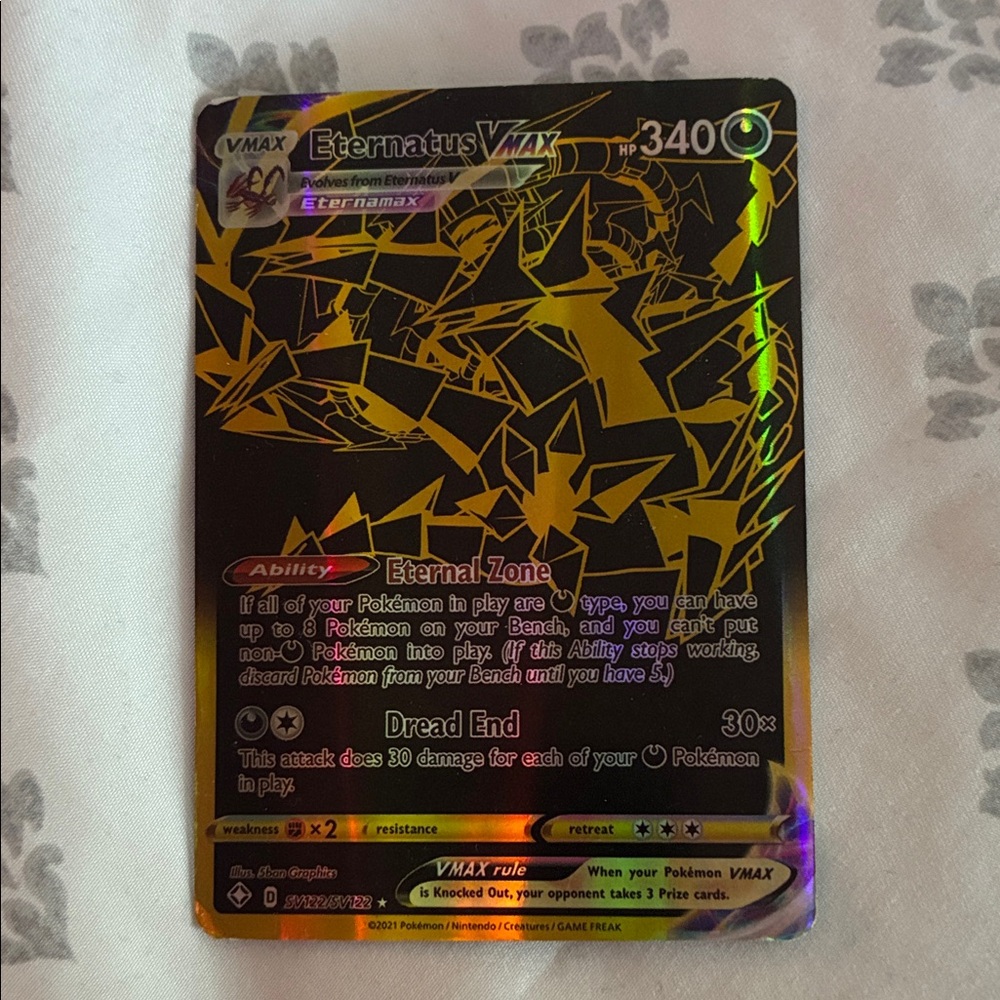 Pokemon Eternatus VMAX Card with Gold and Black Design